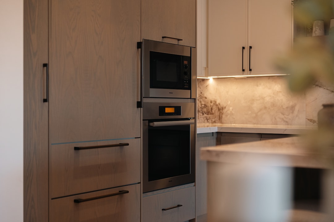 A side-by-side comparison photo showing basic vs midrange vs high-end kitchen finish packages with different cabinet, countertop, and lighting selections