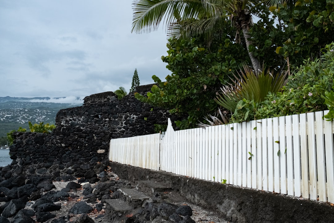 Aerial view of modern homes on an Oahu hillside showing grading, retaining walls, and ocean exposure