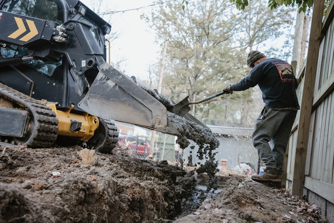Comparison photo showing trenching for sewer lateral vs excavating for septic tank and drainfield